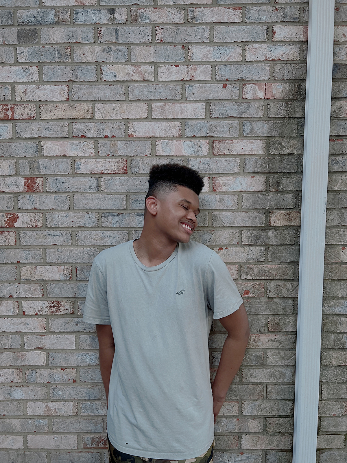 boy smiling and looking over shoulder